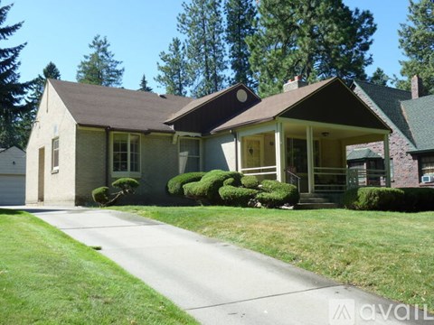 A house with a brown roof and a white garage door.