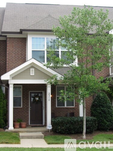 A house with a brown door and a small porch.