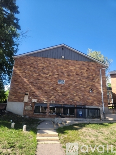 A building with a brick facade and a metal roof.
