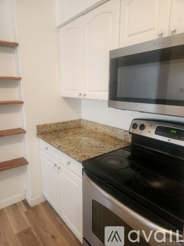 A kitchen with a stove top oven and microwave above it.