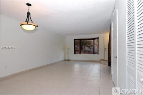 A room with a white ceiling and a white floor with a white wall and a white door.