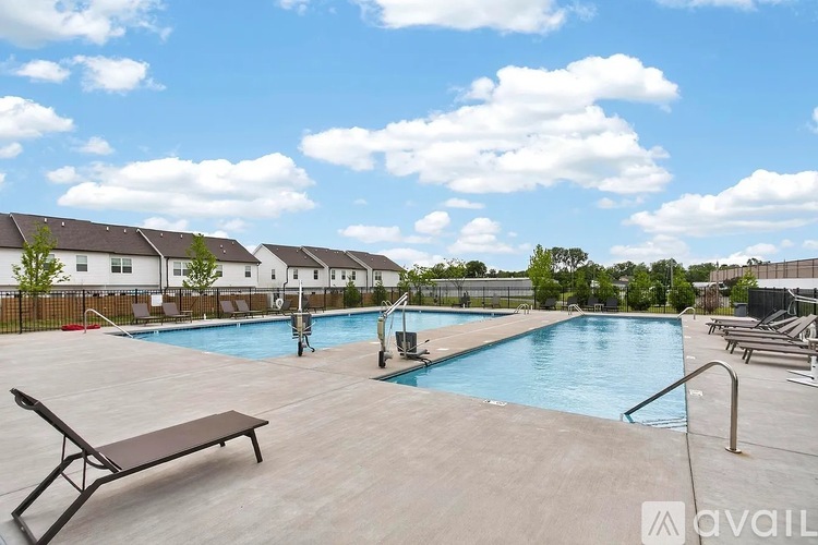 A pool area with a bench and a pool ladder.