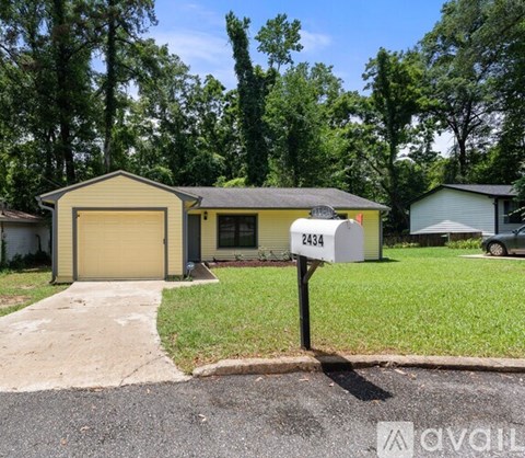 A house with the number 2434 on it is surrounded by greenery.