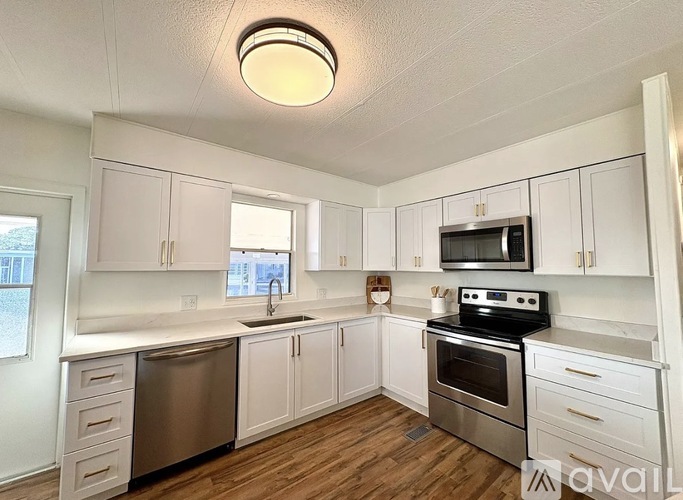 A kitchen with white cabinets and stainless steel appliances.
