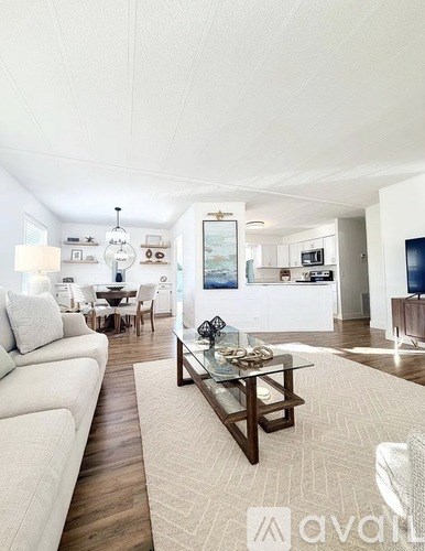 A living room with a white couch and a coffee table.