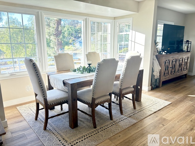 A dining room with a table and chairs.
