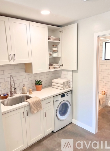 A small white laundry room with a washer and dryer.