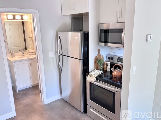 A kitchen with a stainless steel refrigerator and oven.