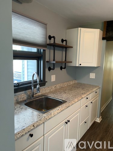 A kitchen with a sink and cabinets.