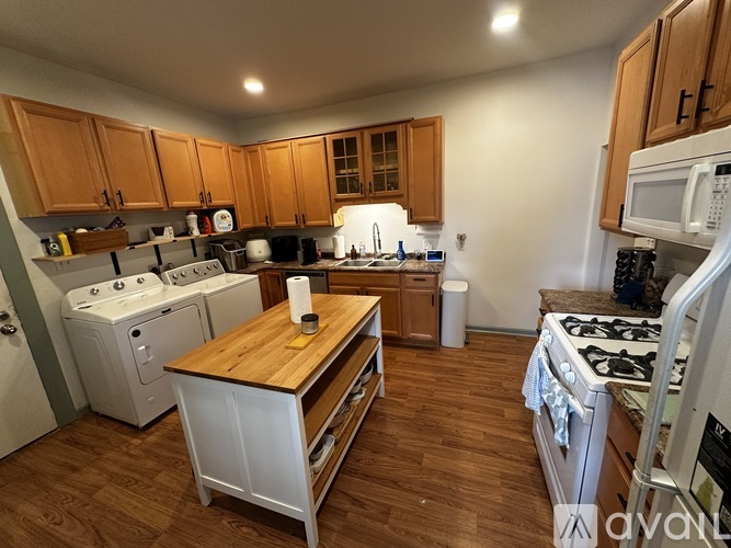A kitchen with wooden cabinets and white appliances.