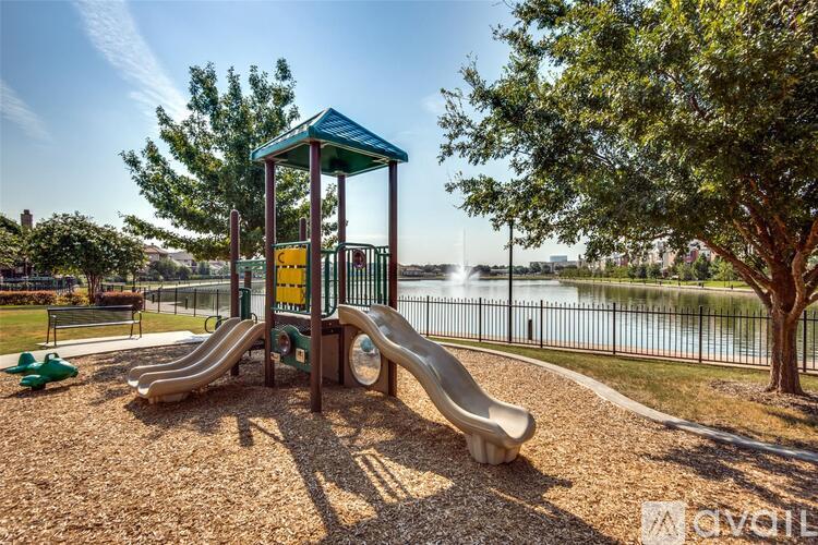 A playground with a slide and a green roofed structure.