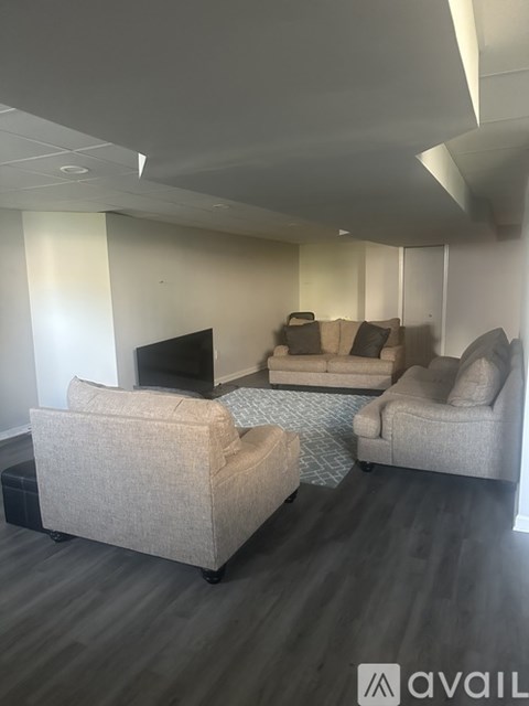 A living room with a television and two couches.