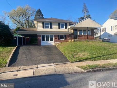 A house with a driveway in front of it is for sale.