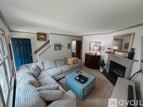 A living room with a grey sofa and a blue coffee table.