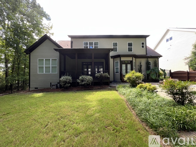 A house with a well-maintained lawn and landscaping in front.