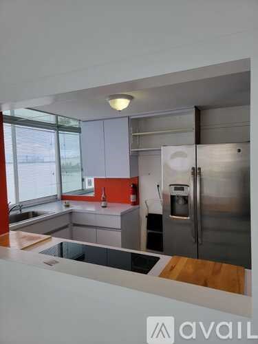 A modern kitchen with stainless steel appliances and a wooden countertop.