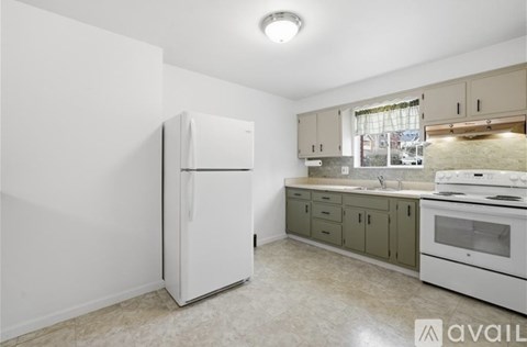 A kitchen with a white refrigerator and a stove top oven.