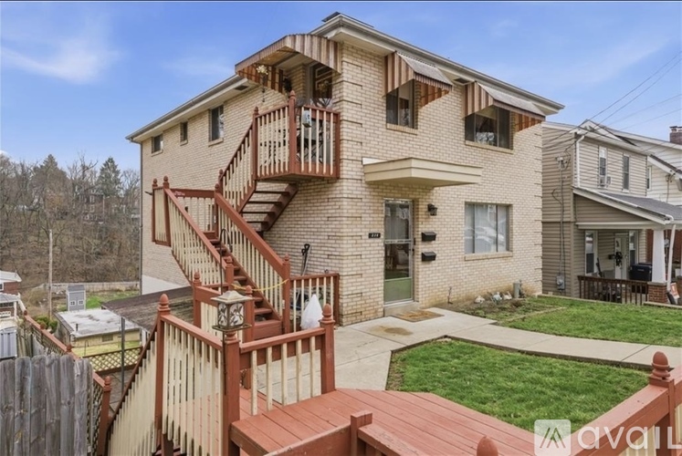 A two-story house with a deck and a balcony.