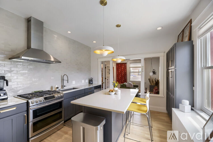 A modern kitchen with a stove top oven and a range hood.