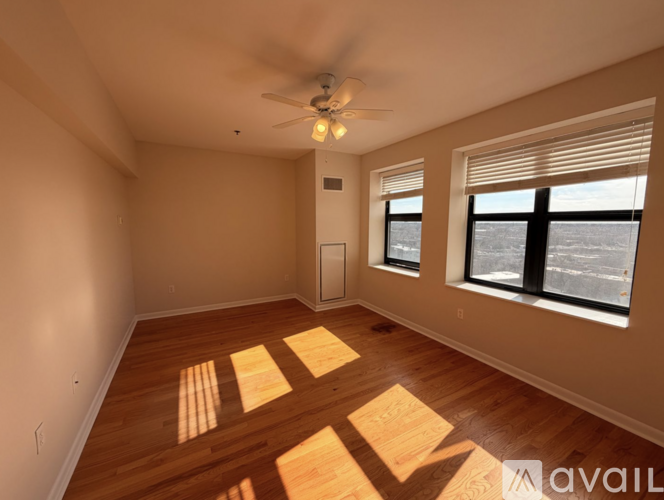 A room with wooden floors and a ceiling fan.