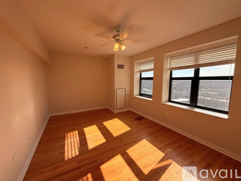 A room with wooden floors and a ceiling fan.