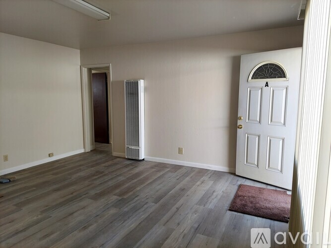 A room with a white door and a window with a white frame.