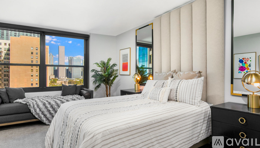 A bedroom with a large bed and a view of the city.