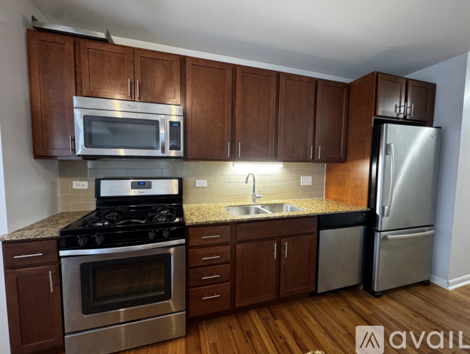 A kitchen with wooden cabinets and stainless steel appliances.