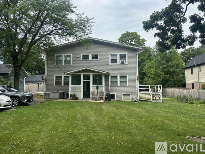 A house with a grey exterior is available for sale.
