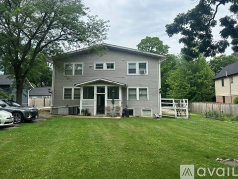 A house with a grey exterior is available for sale.