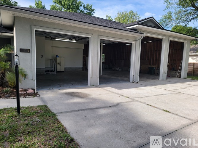A two-car garage with a white exterior and a black roof.