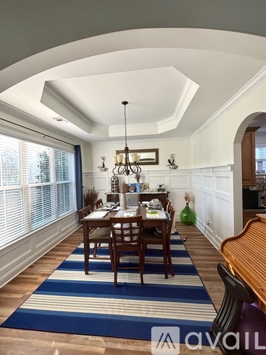 A dining room with a table set for a meal.