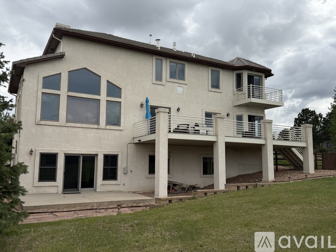 A two-story house with a balcony on the second floor.