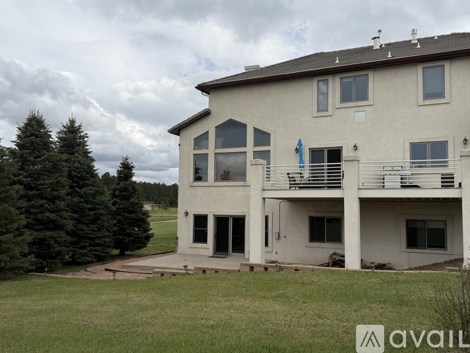 A large house with a balcony and a flag on it.