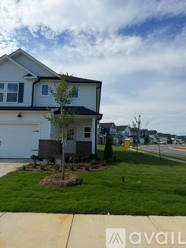 A house with a tree in front of it.
