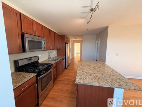A kitchen with wooden cabinets and a granite countertop.
