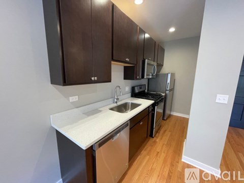 A kitchen with brown cabinets and a white countertop.