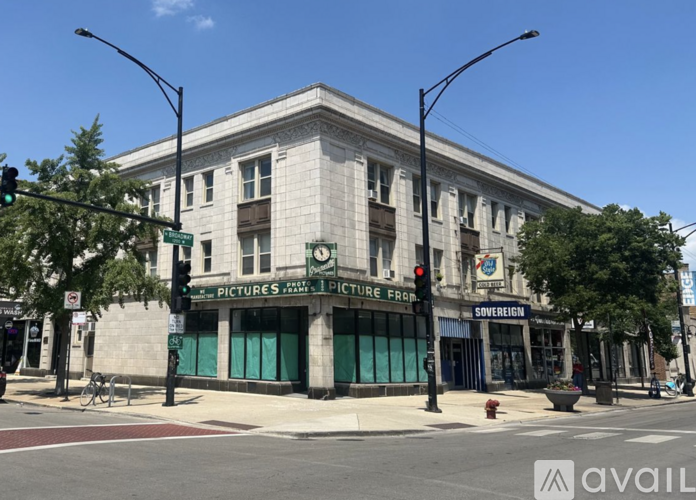 A street view of a building with a green awning and a sign that reads "PICTURES PICTURE FRAME".