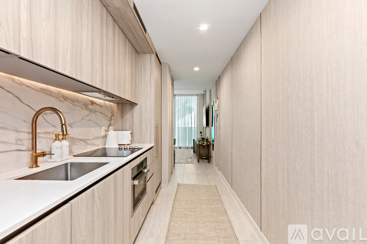 A modern kitchen with a marble backsplash and stainless steel appliances.