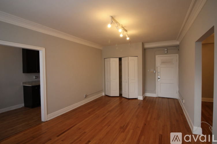 A room with wooden floors and a white door.