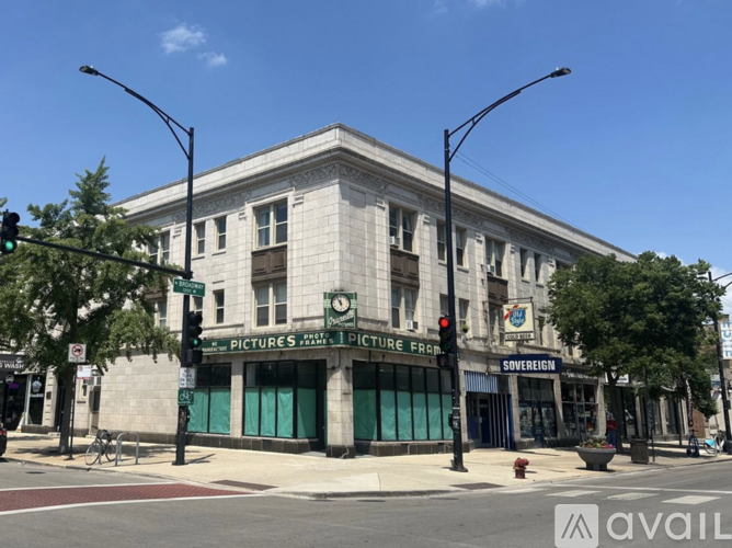 A street view of a building with a green sign that says "PICTURES" on it.