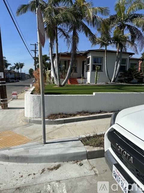 A Toyota car is parked on the side of a street.