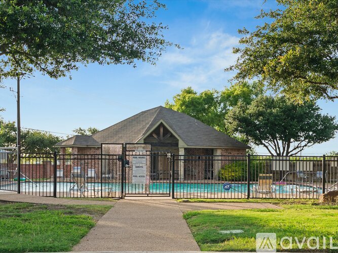 A small building with a pool in front of it.