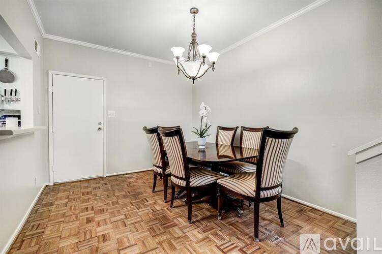 A dining room with a wooden table and chairs.