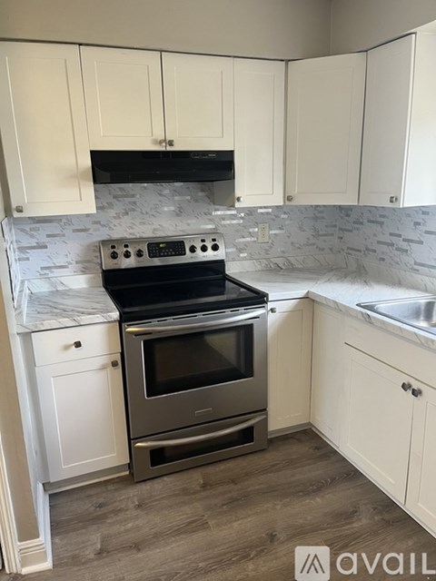 A kitchen with a stove top oven and a dishwasher.