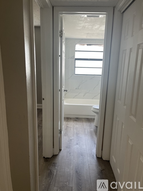 A bathroom with a toilet and a window.