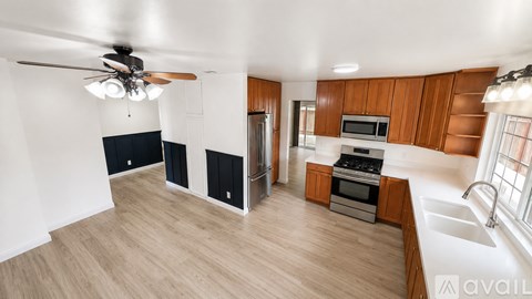 A kitchen with wooden cabinets and a black stove top oven.