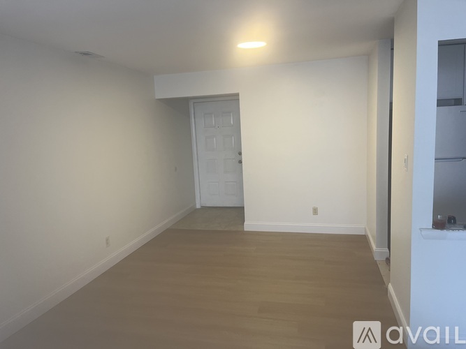 A room with a white door and a white wall.