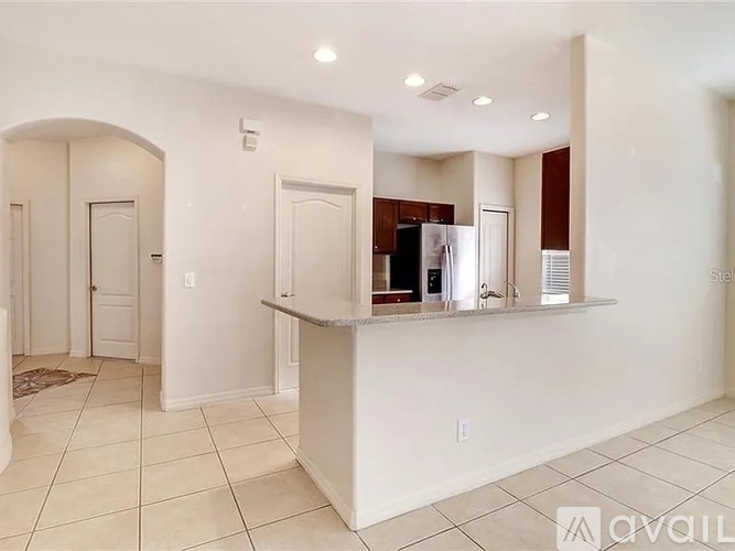 A white kitchen with a counter and cabinets.