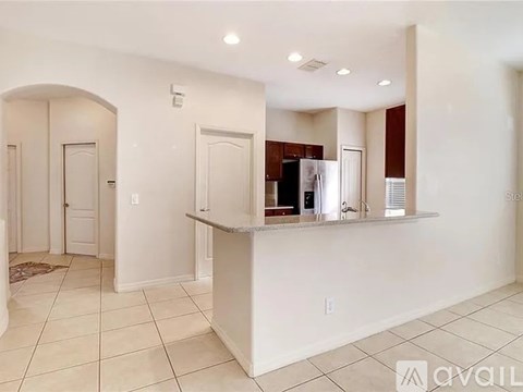 A white kitchen with a counter and cabinets.